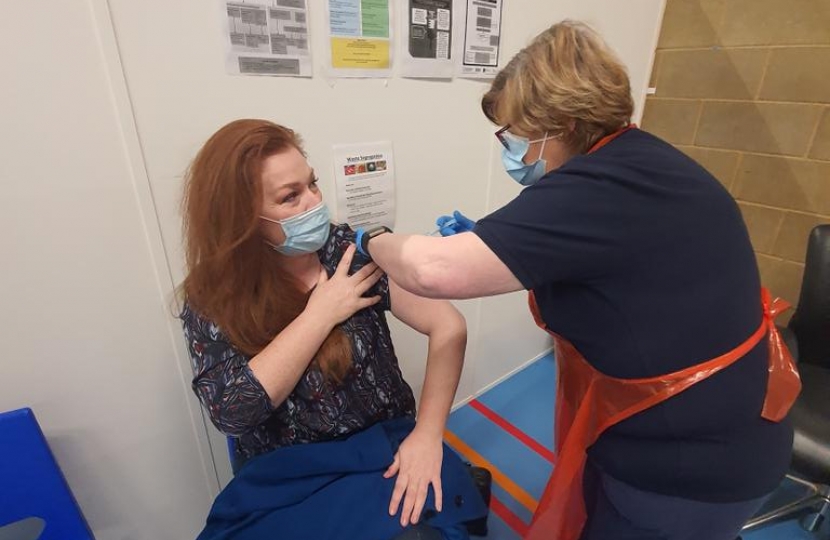 Jane receiving her vaccine