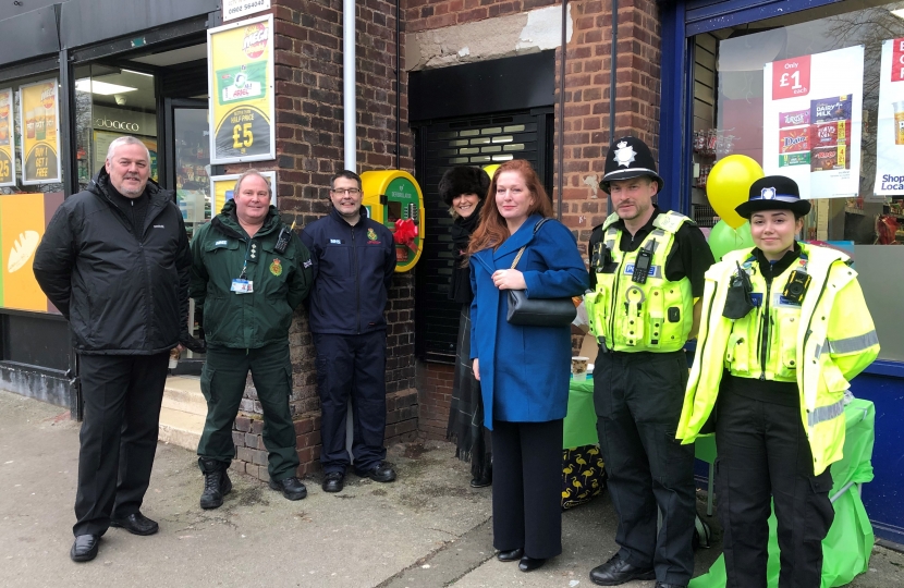 Jane (centre) at the unveiling of the defibrillator